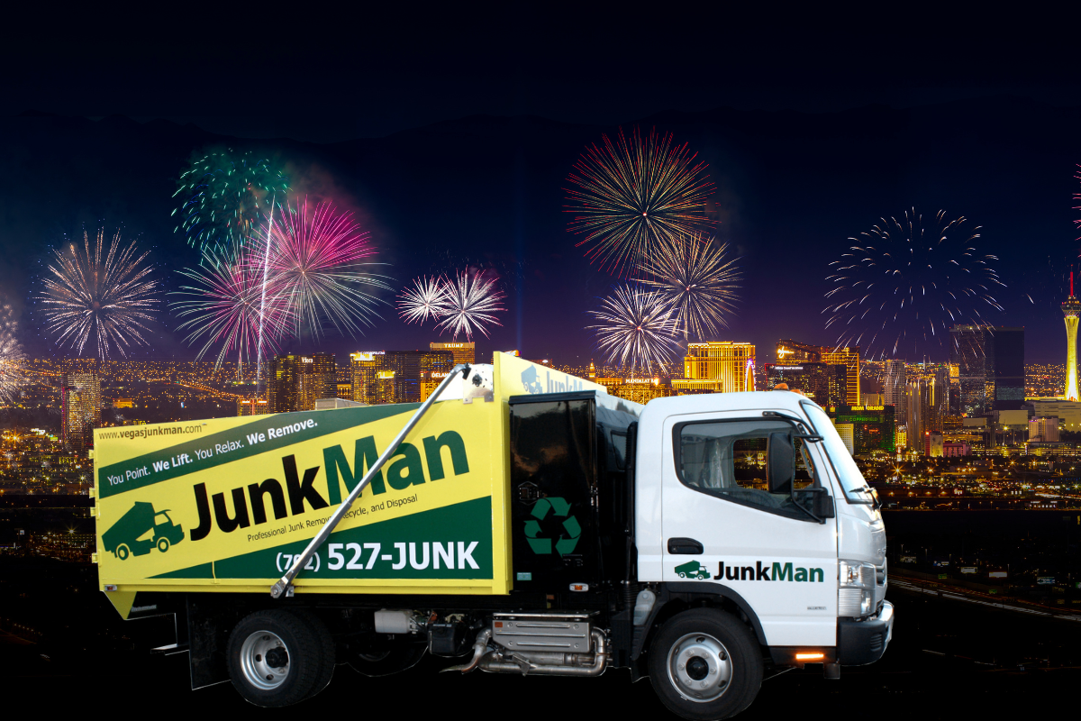 Junk removal truck with fireworks over city skyline.