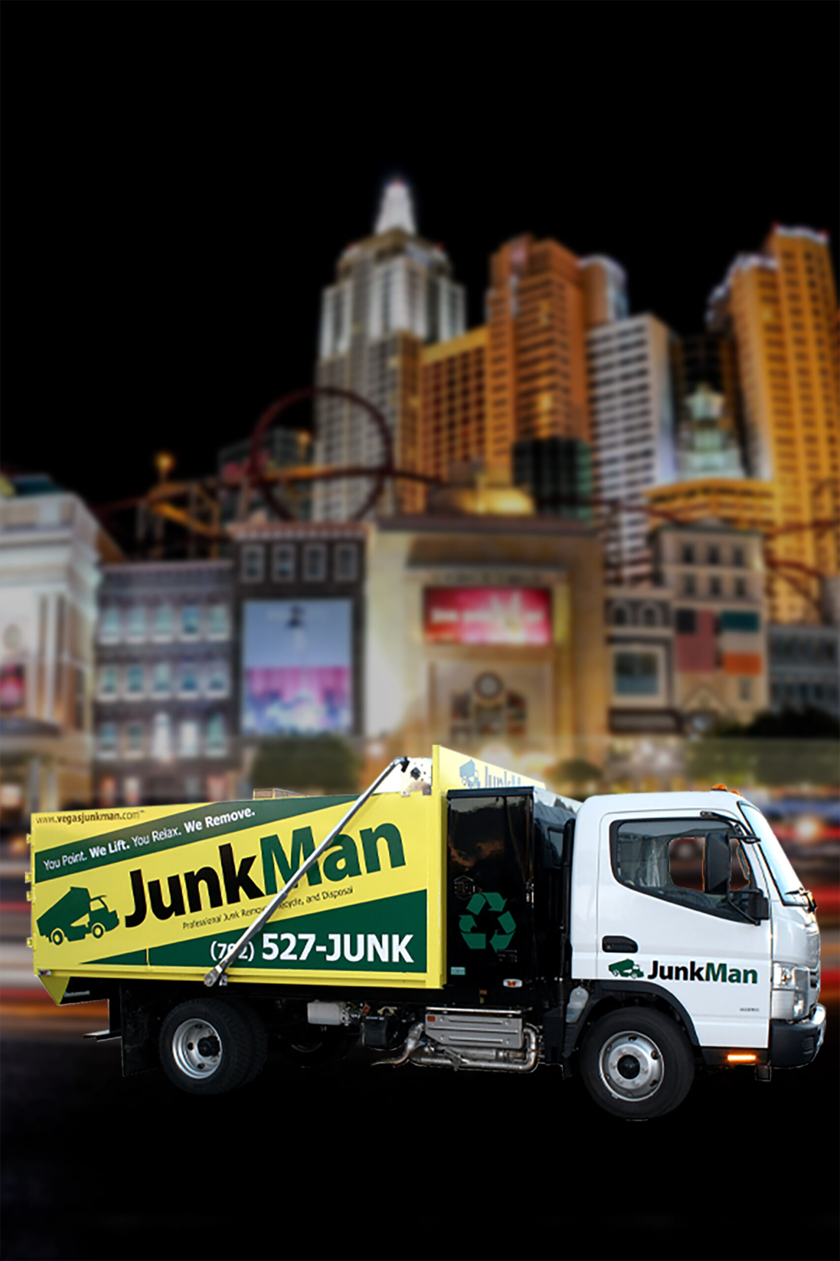 JunkMan truck in city at night.