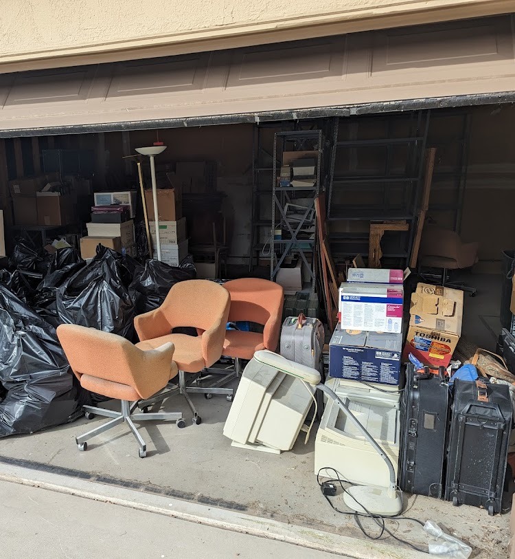 Garage with furniture and household items before furniture removal in Las Vegas